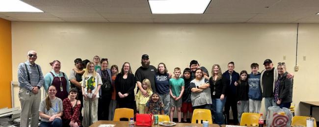 SFP graduates gathered in a classroom space